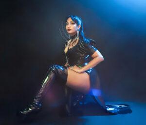 Scarlet Vexus, Dominatrix in Austin, wearing a black latex attire made by her 
